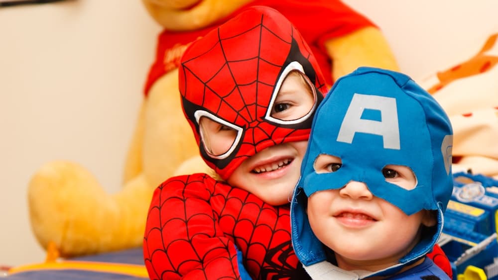 Kids in superhero costumes